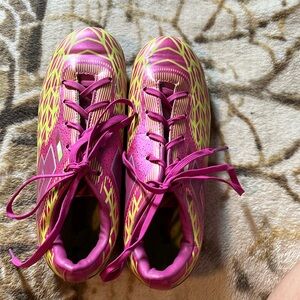 Pink and green soccer cleats have been used.